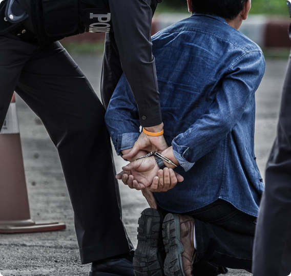 Person being handcuffed and arrested by police