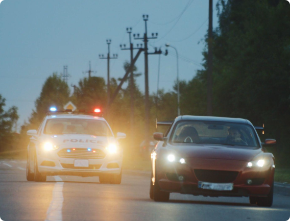 Police vehicle pulling over a car on a highway