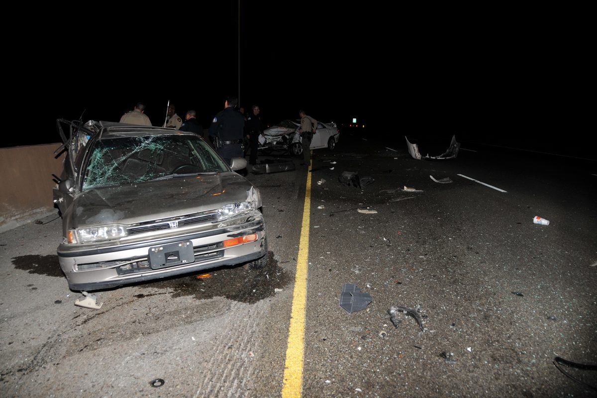 Officers investigating a nighttime crash scene during a DUI investigation